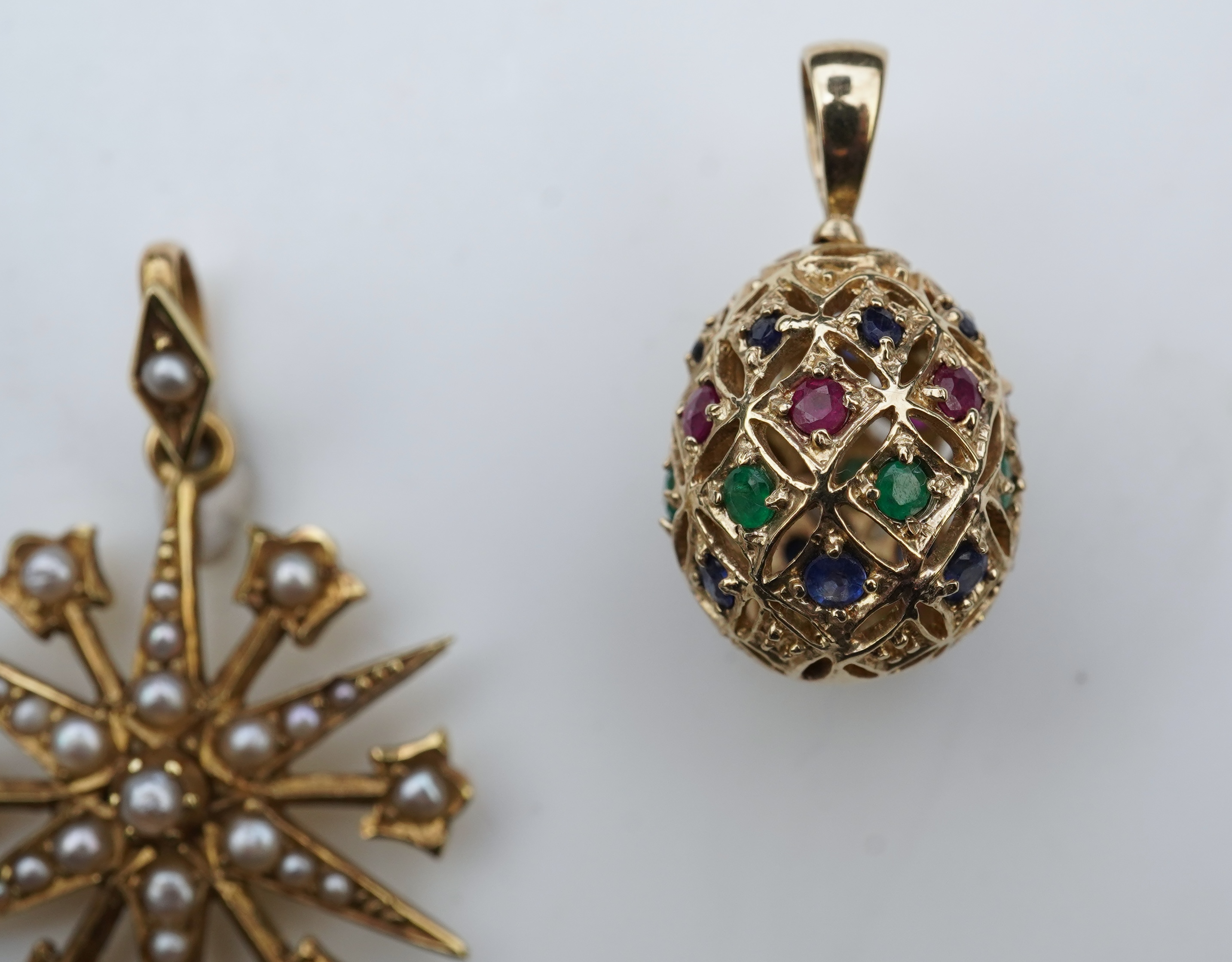 A gem-set egg pendant and an Edwardian seed pearl pendant